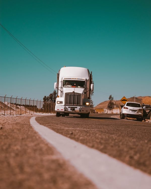white freight truck on grey concrete road